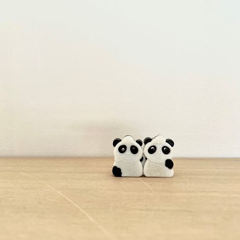 Baby panda among the pandas